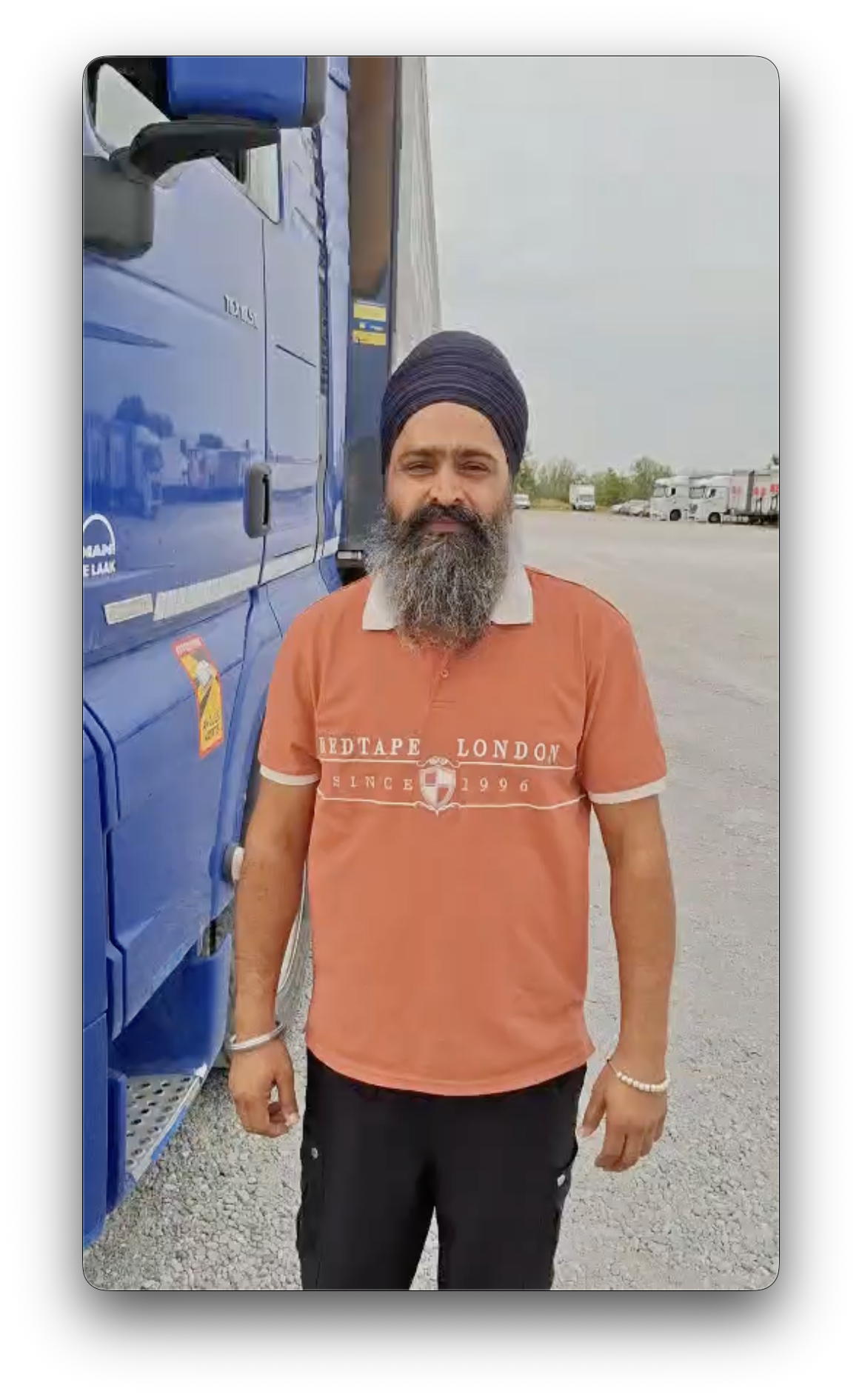 Șofer profesionist lângă un camion într-o parcare pentru vehicule comerciale